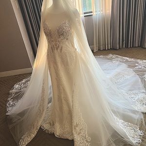 Wedding dress with detachable skirt in a size 12. Color is in ivory.